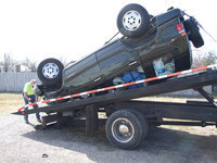 Image: Unfortunate Accident — Caitlin McCown’s Isuzu Trooper was towed in upside down by Helm’s Garage after an accident on Chambers Creek Bridge Friday about 10:45 a.m.