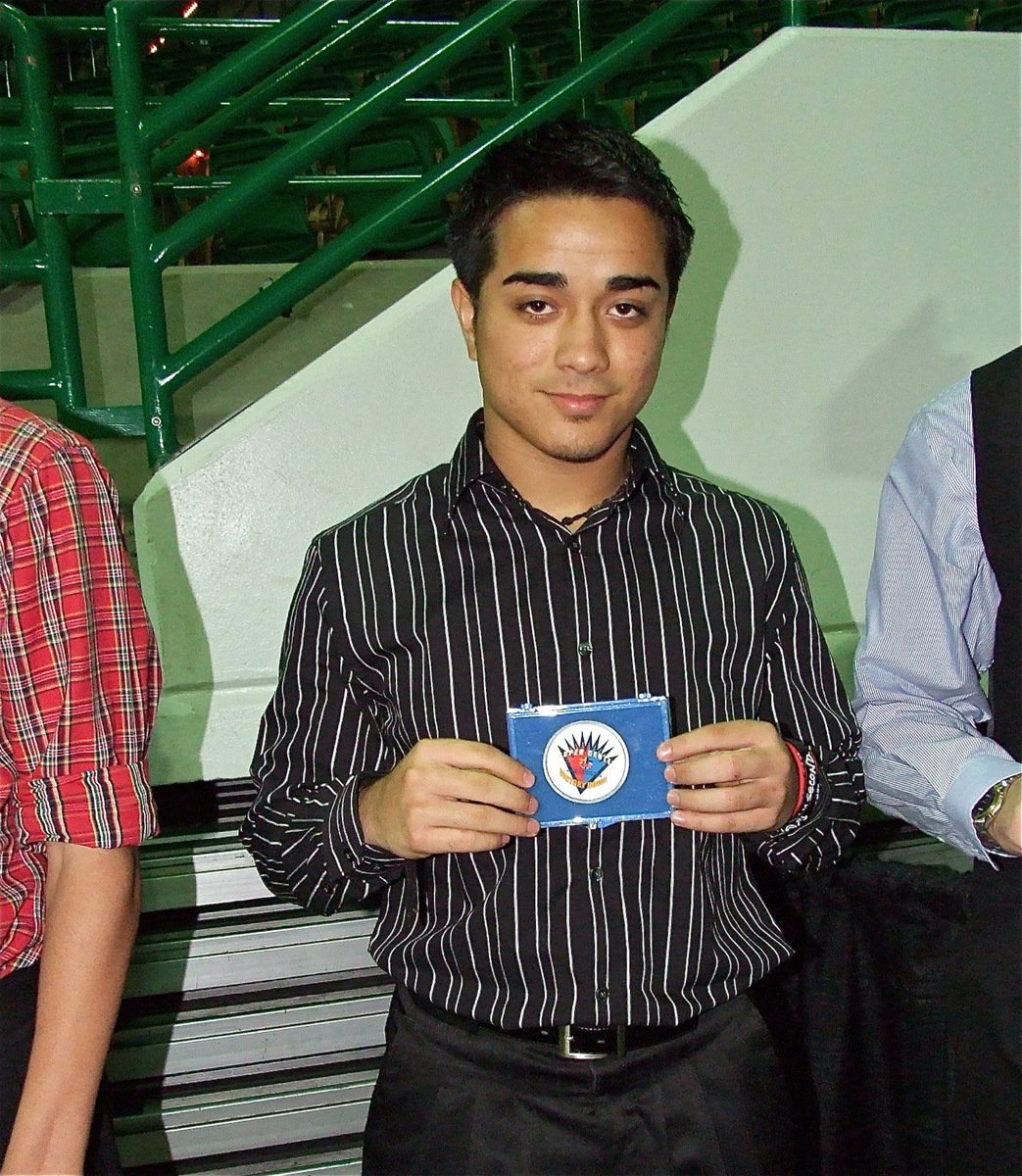 Image: Rolando Vega — Milford Bulldog football star, Rolando Vega, displays his Victory Bowl medal after being recognized during the FCA All-Star Victory Banquet in Waco.