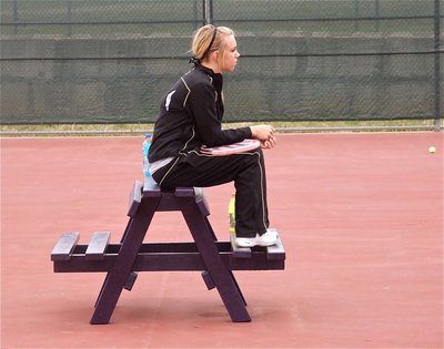 Image: Sitting in Alvarado — Sierra Harris watches her tennis teammates warming up.