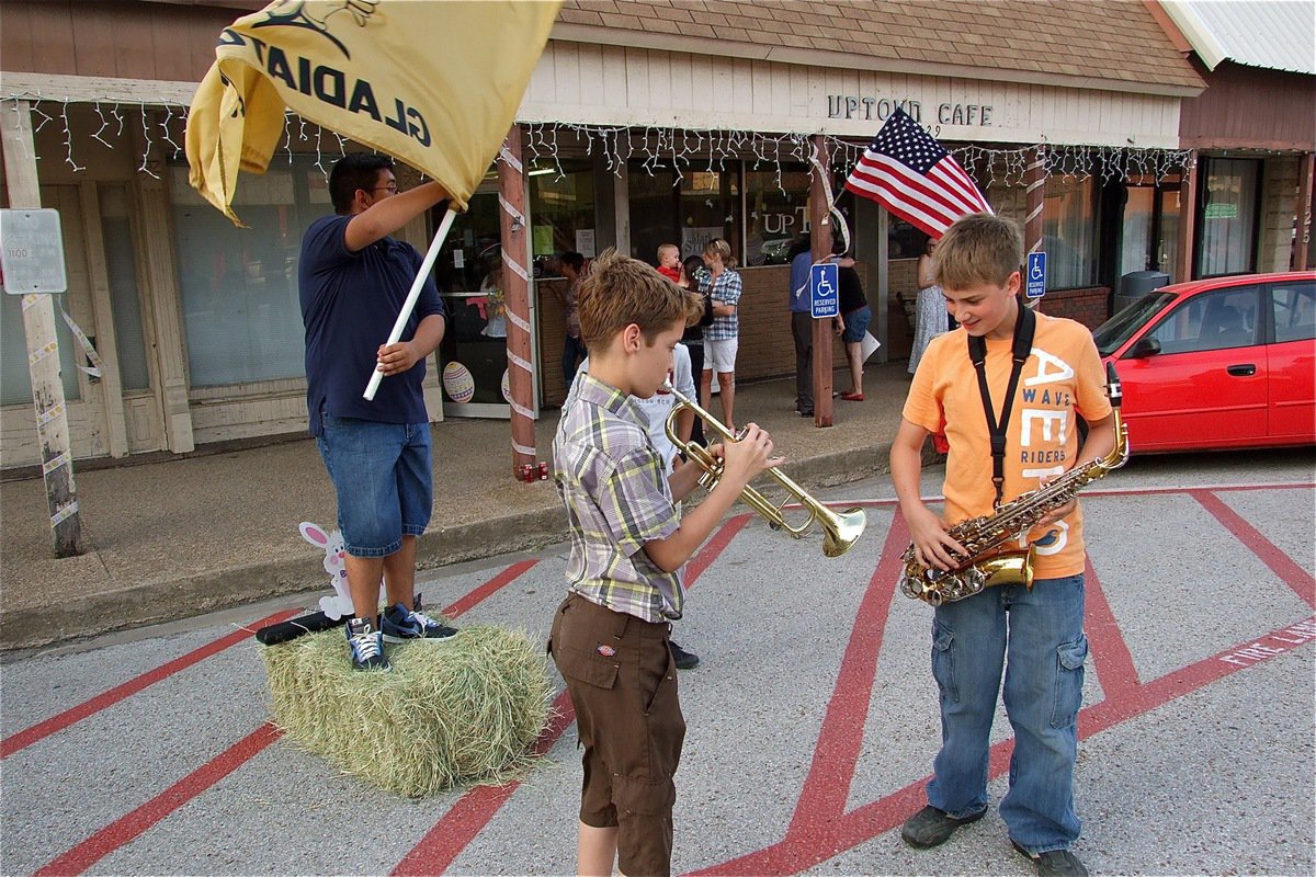 Image: Attention getters — Pedro Salazar waves the Italy Gladiator flag while Carl Jaynes and Brandon Connor rely on their musical talents to entice passing cars to park and enter the Uptown Cafe in downtown Italy for a spaghetti dinner.