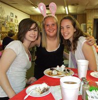 Image: Easter feast — Meagan Hooker, Drenda Burk and Melissa Smithey are all smiles after enjoying their spaghetti.