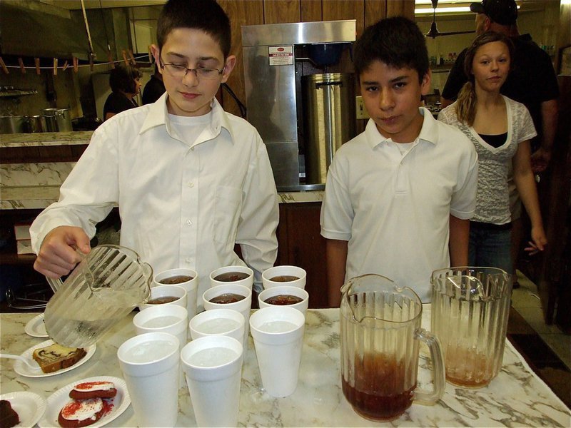 Image: Drink servers — Drink servers, Tristin Oldfield and Jaun Suaste, work diligently to keep patrons refreshed during the Gladiator Regiment Band’s spaghetti dinner.