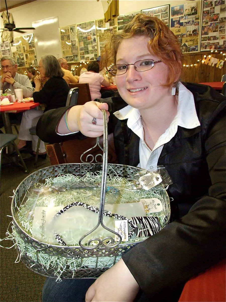 Image: Door prizes — Kaitlan Davidson displays her jewelry filled easter basket.