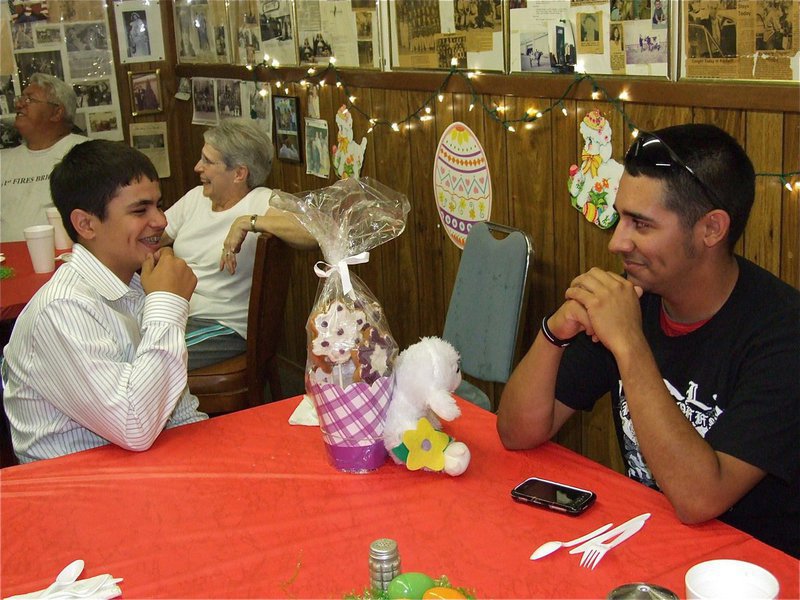 Image: Big winner — Reid Jacinto thinks Michael “Taz” Martinez looks cute with his basket of cookies and stuffed Easter rabbit door prize.
