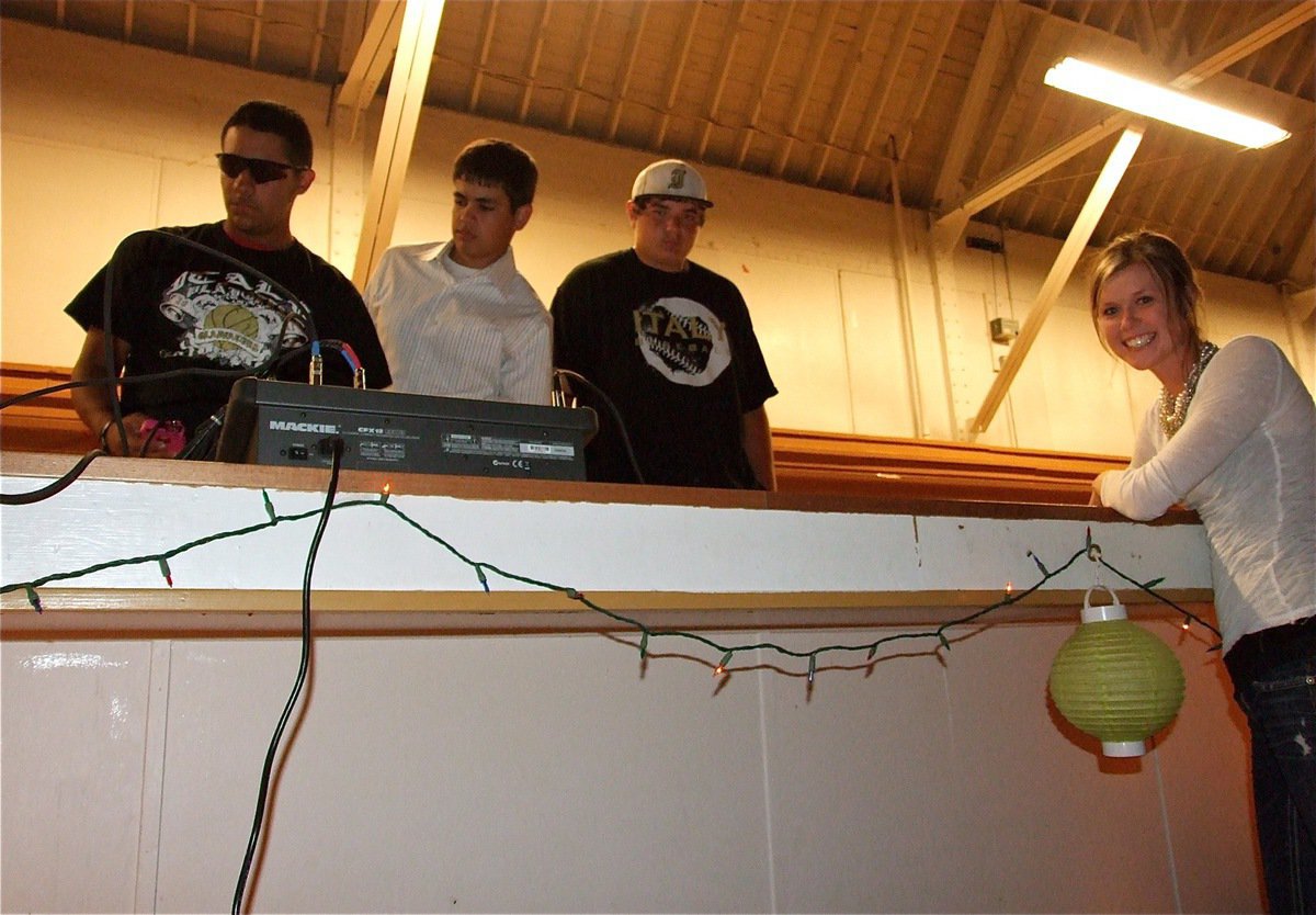 Image: At the dance — Michael “Taz” Martinez, Reid Jacinto and Kevin Roldan keep the music flowing inside the old Italy gym while, Kaitlyn Rossa, puts in a song request.