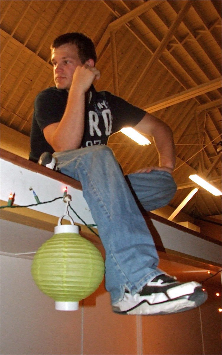 Image: Quick break — Chase Hamilton relaxes near the DJs before performing live at the Gladiator Regiment Band hosted Spring Dance.