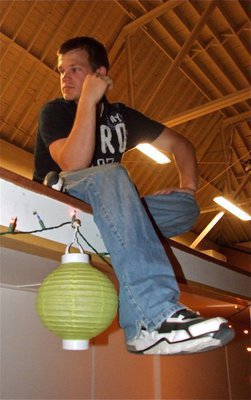 Image: Quick break — Chase Hamilton relaxes near the DJs before performing live at the Gladiator Regiment Band hosted Spring Dance.
