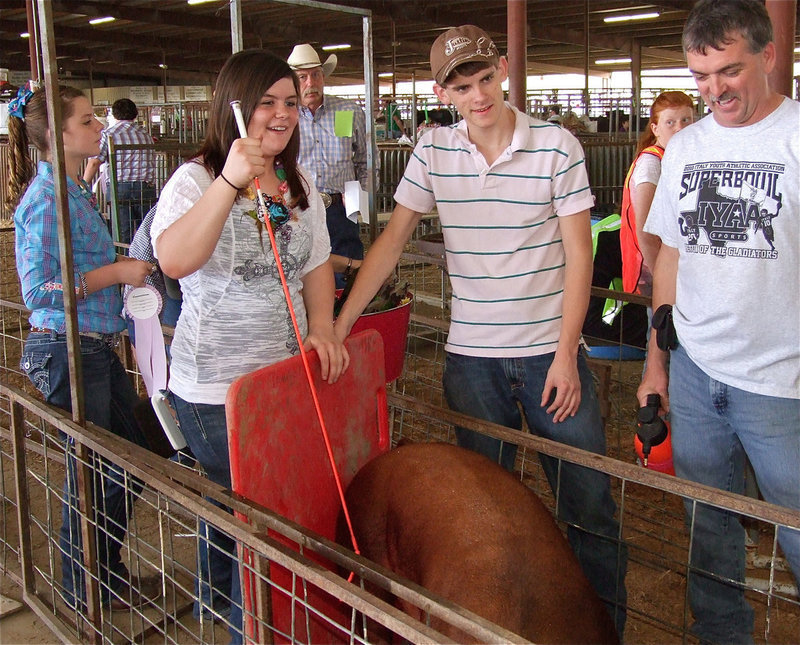 Image: This is serious — Gary Wood (far right), Justin Wood, Bailey DeBorde and Brooke Deborde (far left) enjoy a light moment before the sale.