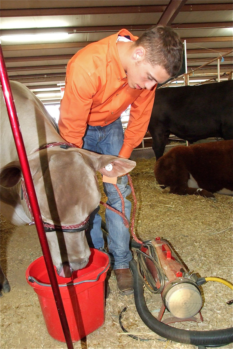 Image: Brandon Souder — Brandon Souder does some last minute maintenance before the Thursday show.