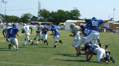 Image: The “beast” is loose — Jasenio “Beast” Anderson breaks loose from a pack of Lions for a big gain.