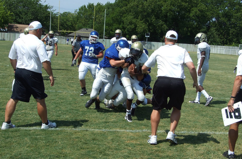 Image: Heath hangs on — The talented Heath Clemons draws some unwanted attention from the Lions defense.