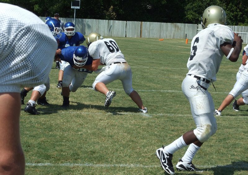 Image: Drop back pass — Ross Enriquez tries to buy Jasenio Anderson a little time to make the throw.