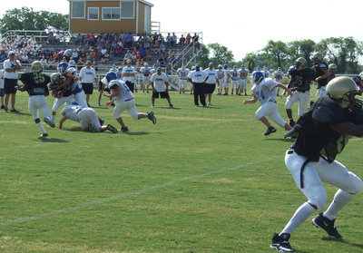 Image: Busted play — The Blooming Grove defense mistook Italy JV quarterback Tony Wooldidge for a cut of raw steak on this play.