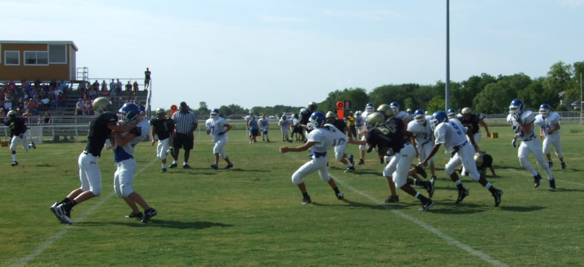 Image: Stalking a Lion — Blooming Grove’s quarterback is unable to sneak past the JV Gladiator’s defense line.