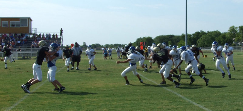 Image: Stalking a Lion — Blooming Grove’s quarterback is unable to sneak past the JV Gladiator’s defense line.