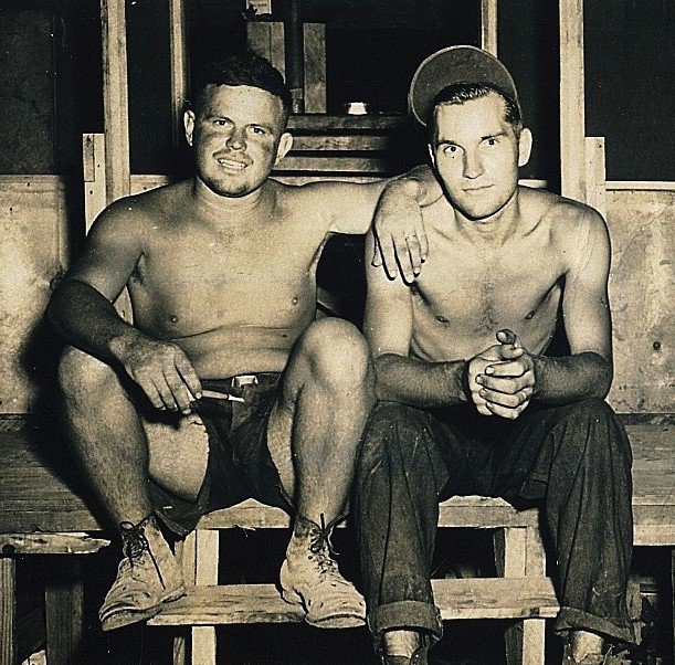 Image: In Okinawa — Kenneth Bryant sits with his Naval unit’s photographer on the Japanese island of Okinawa during World War II.