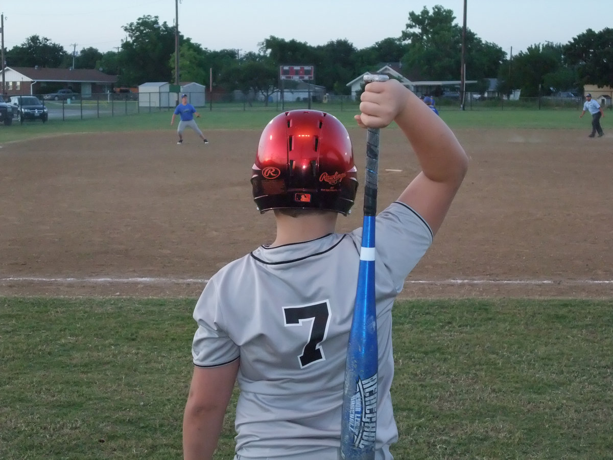Image: Zain stretches — Zain Byers goes through his stretching routine inside the batters box. Byers went on to score 2 of Italy’s 18-points in their 18-1 victory.