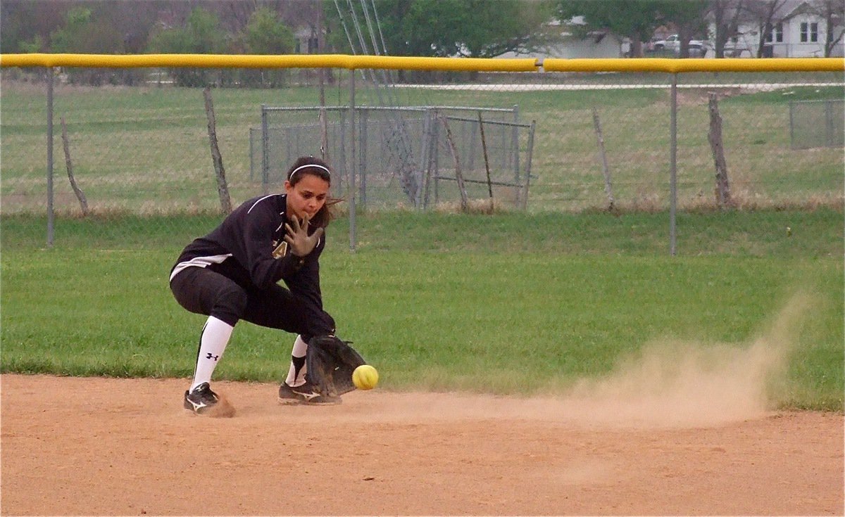 Image: On the ball — Shortstop, Anna Viers, collects a ball during warmups between innings in Clifton.