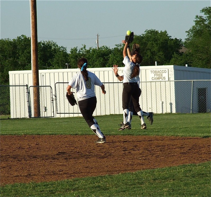 Image: Had it all the way — Morgan Cockerham(8) holds her breath as, Anna Viers(11), makes the catch while avoiding a collision with, Bailey Bumpus(18), during the Grandview game.
