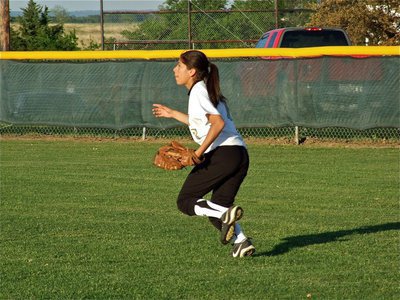 Image: Keep working — Right fielder, Alma Suaste(7), helps back up a throw to second base.