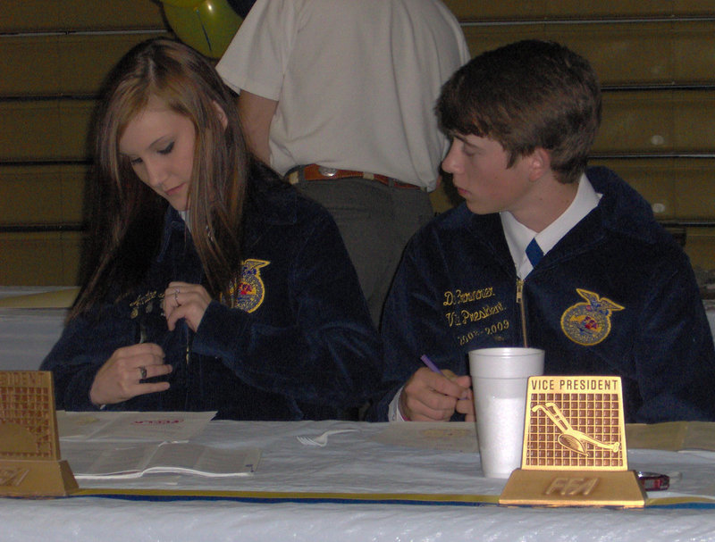 Image: Let me see… — Annalee Lyons shows off her medal to everyone but Dan Crownover.