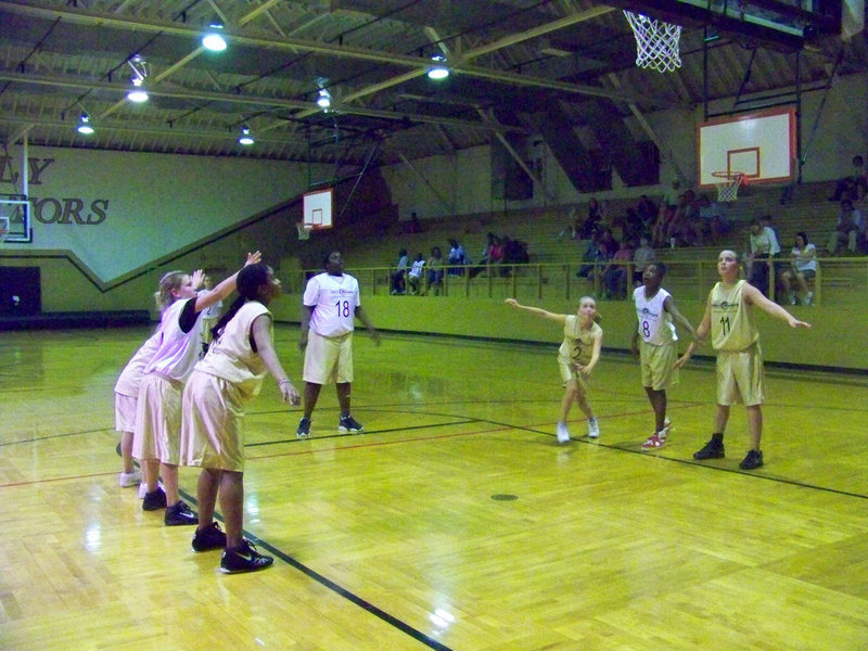 Image: Put your little foot — Hanna Washington #2 puts her little foot in the lane while Shercorya “Cory” Chance #18 encourages the shot to go in the basket.