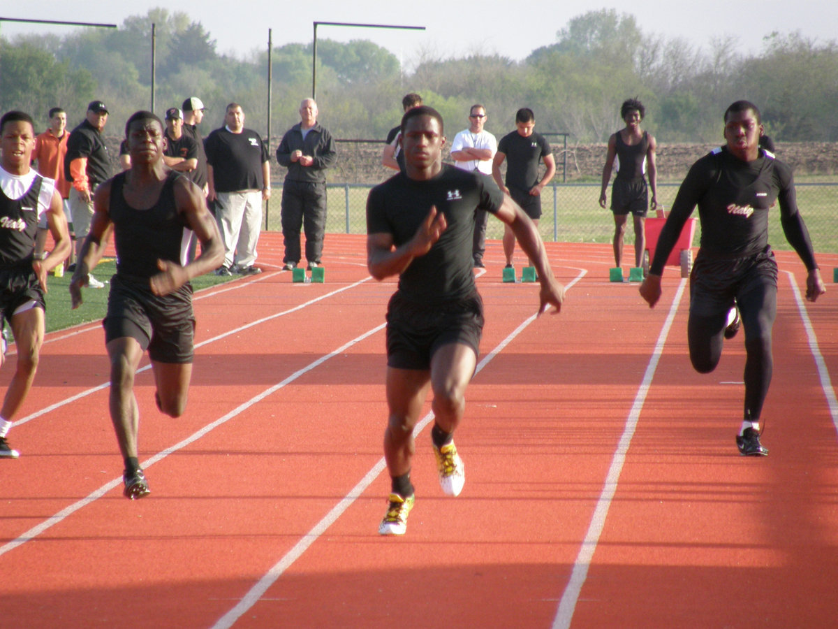 Image: Cole blooded — Senior trackster Curtis Cole (on the right in lane 2) rips his way down the track at Ferris High School.