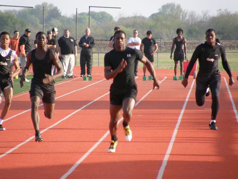 Image: Cole blooded — Senior trackster Curtis Cole (on the right in lane 2) rips his way down the track at Ferris High School.