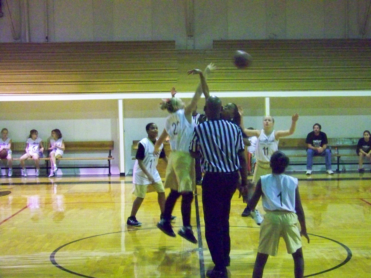Image: Italy 23 tips-off — Italy’s #22 Jaclynn Lewis swats the jump ball to an open teammate.