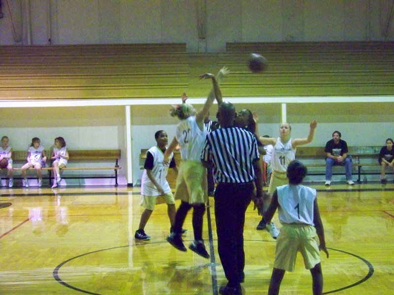Image: Italy 23 tips-off — Italy’s #22 Jaclynn Lewis swats the jump ball to an open teammate.