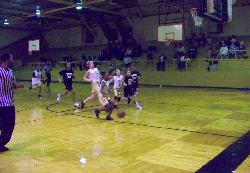 Image: KaBreona Davis — KaBreona Davis charges toward the basket for a score against Hillsboro as #13 Tylar Wilson, #11 Madison Washington and #9 Tara Wallis follow.