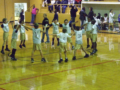 Image: Jumping For Joy — Italy 19 celebrates their team’s victory in the center circle with jumping jacks.