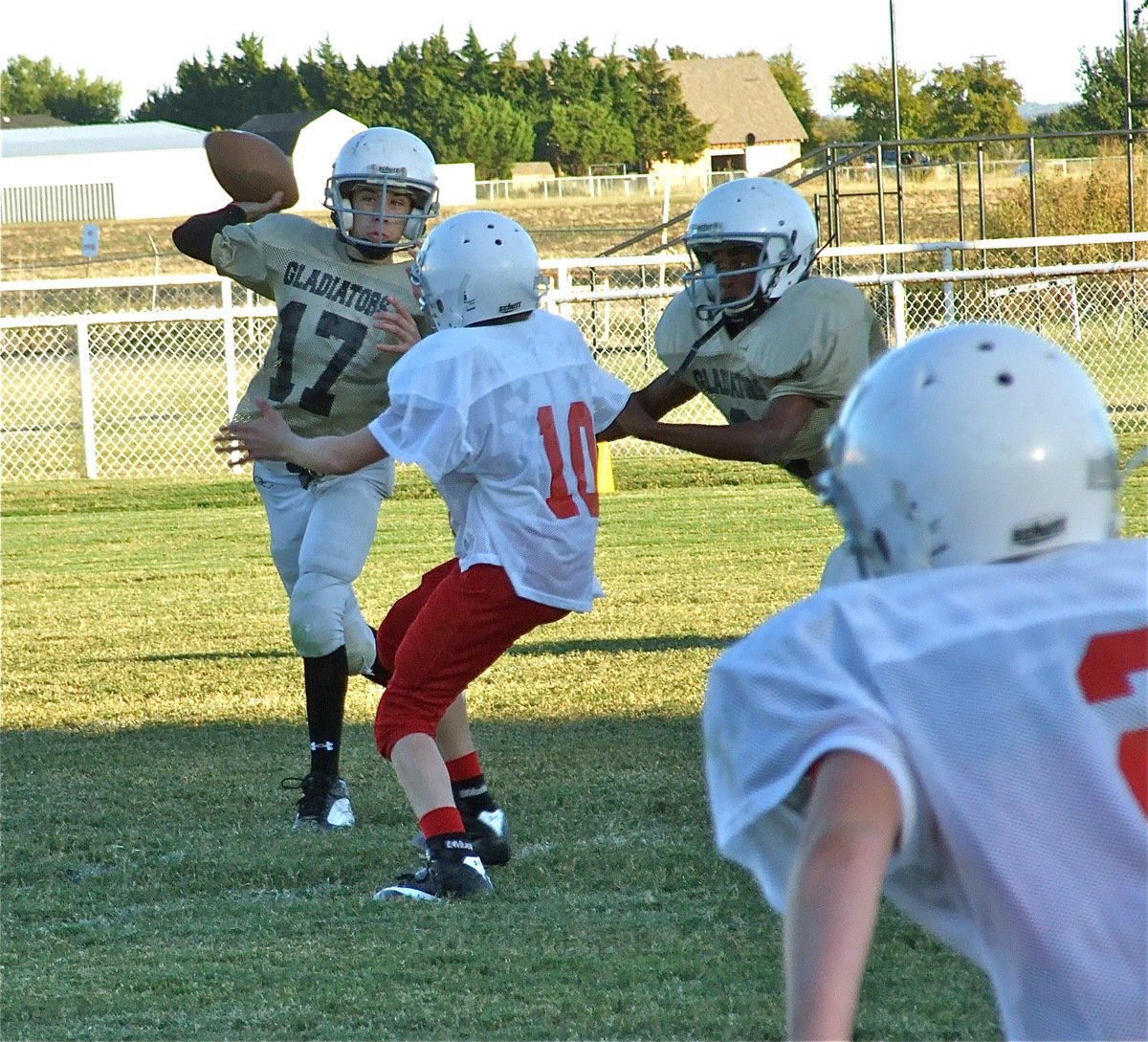 Image: In the pocket — Ryan Connor(17) passes down field while JaRay Anderson(9) provides the protection.