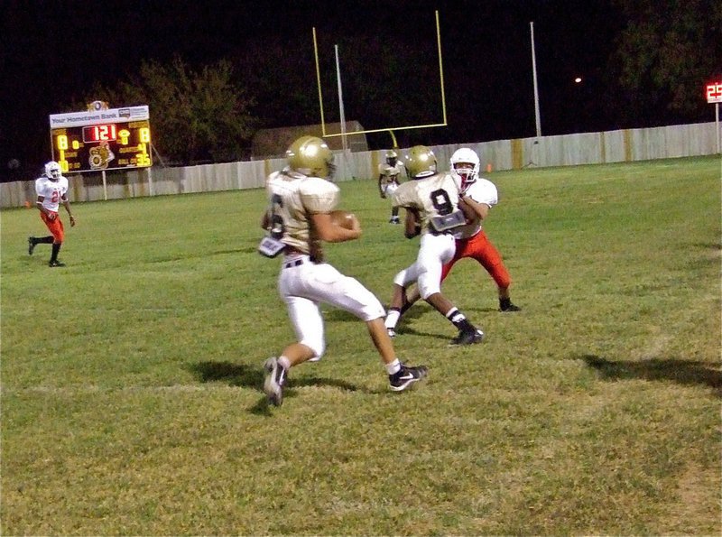 Image: Follow me — Quarterback Tony Wooldridge(6) gains extra yards thanks to the downfield blocking of teammate Trevon Robertson(9).