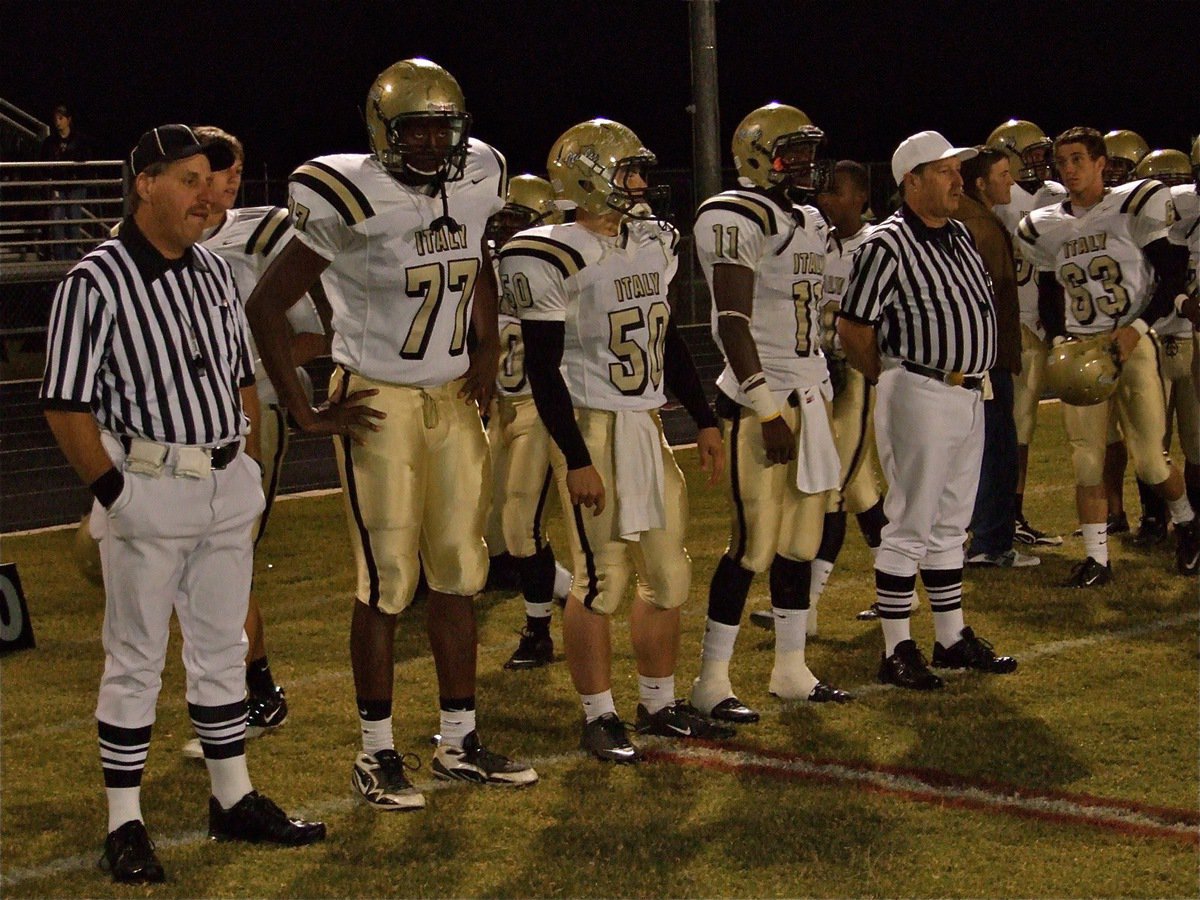 Image: The Captains — Italy’s Larry Mayberry(77), Ethan Simon(50) and Jasenio Anderson(11) are ready to represent the Gladiators at midfield for the coin toss.