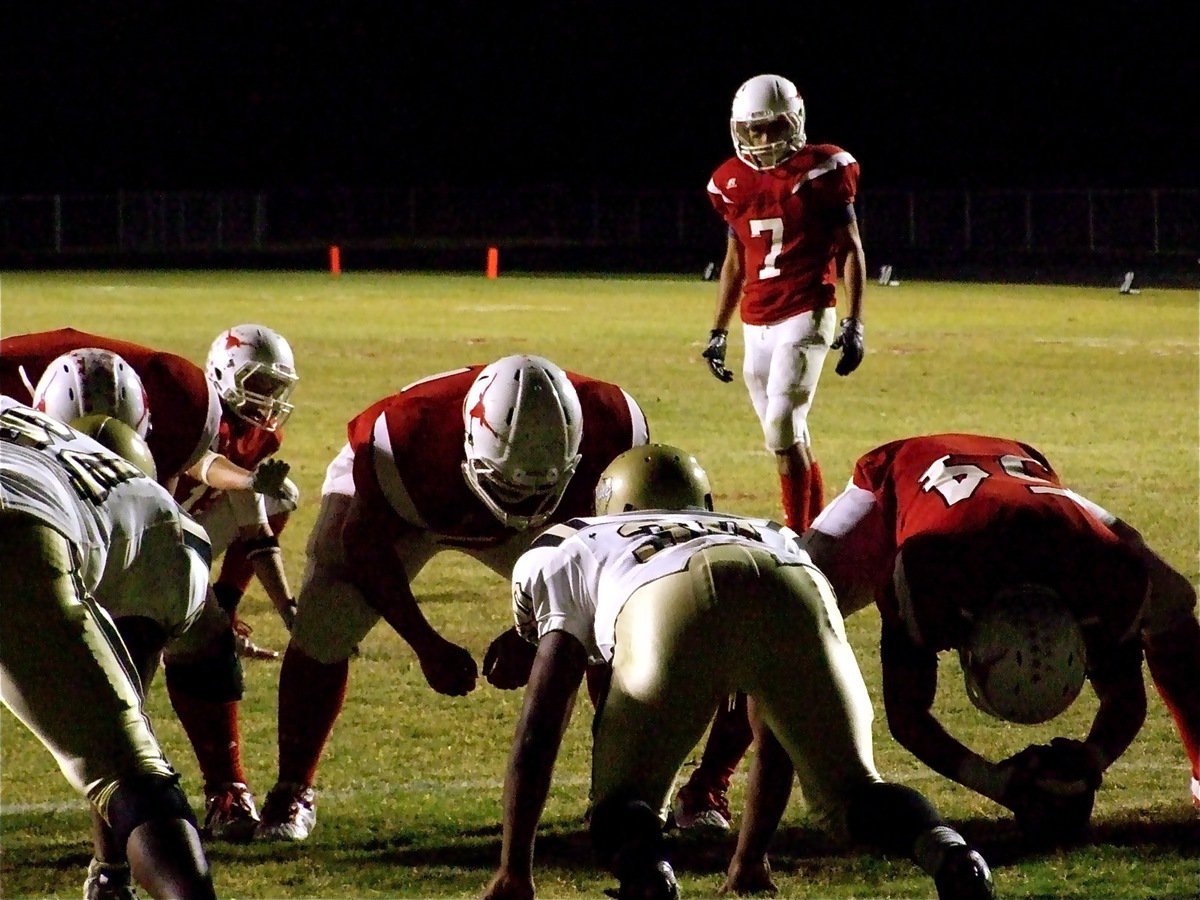 Image: Extra point try — Bobby Wilson(64) and Jamal Jalarnce Lewis(30) get set to try and block a field goal attempt by Mykel King(7).