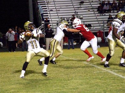 Image: The launch — Jasenio Anderson(11) is about to launch the deep ball as Brandon Souder(63) and Bobby Wilson(64) keep the Longhorns out of the passing pocket.