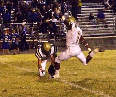 Image: The point after — Jase Holden(6) holds for kicker Jasenio Anderson(11) during the point after kick.