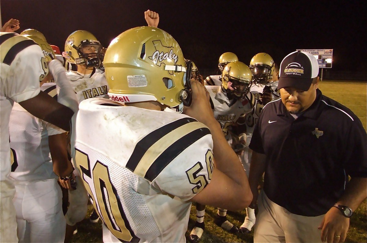 Image: Victory is ours! — Italy celebrates their 48-34 win over Blooming Grove with head coach Craig Bales after overcoming a bit of adversity to get the victory. Unfortunately, for the rest of the district, the Gladiators will be even stronger now.
