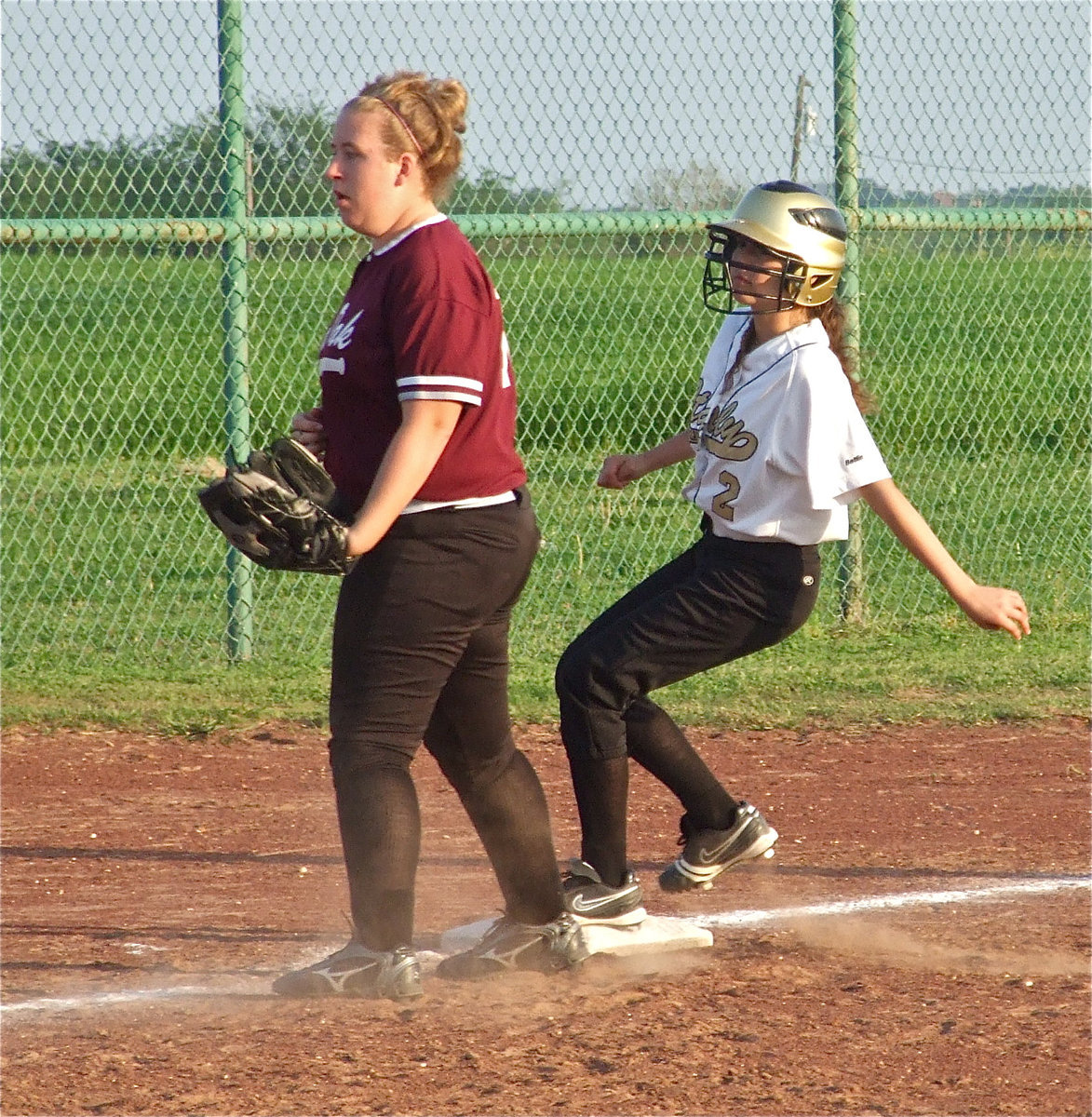 Image: Getting away with it — Paola Mata steels 3rd base against Red Oak.