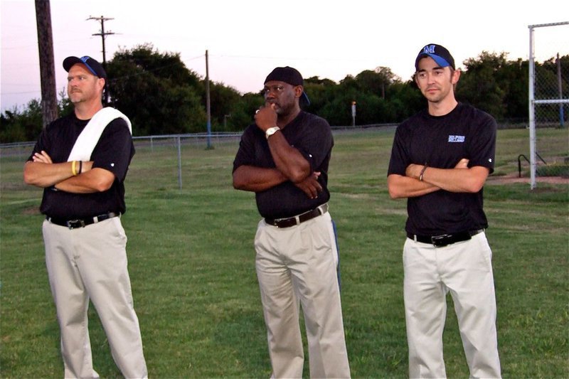 Image: On the outside — Milford Bulldog coaches Ronny Crumpton, Otis Carter and Caleb Cox remain calm, on the outside, moments before taking the field.
