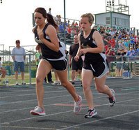 Image: Working together — Breyanna Beets finishes in 1st place and teammate, Felicia Little, finishes in 6th place during the 800 meter run.