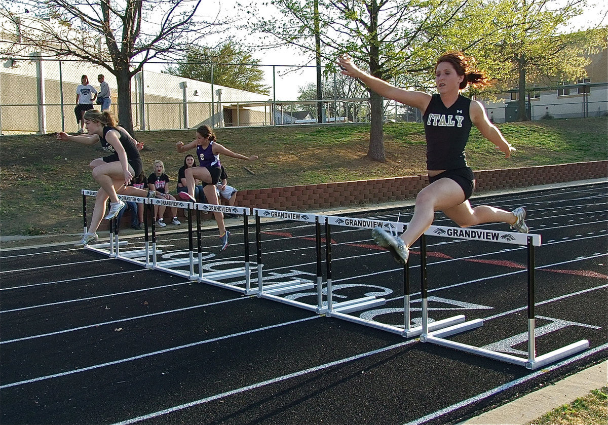 Image: How it’s done — Taylor Turner takes 1st place, Bailey Bumpus takes 2nd place and Imke Klindworth finishes in 4th place during the 100 meter hurdles.