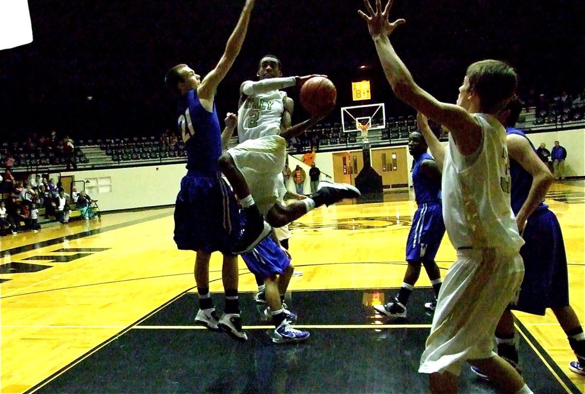 Image: 2 athletic to stop — Gladiator Heath Clemons(2) dazzles down the lane as teammate Jase Holden(3) calls for the ball.