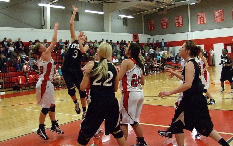 Image: Air Rossa — Kaitlyn Rossa(3) flies in with a lay in while teammates Megan Richards(22) and Bailey Bumpus(13) head for the rebound.