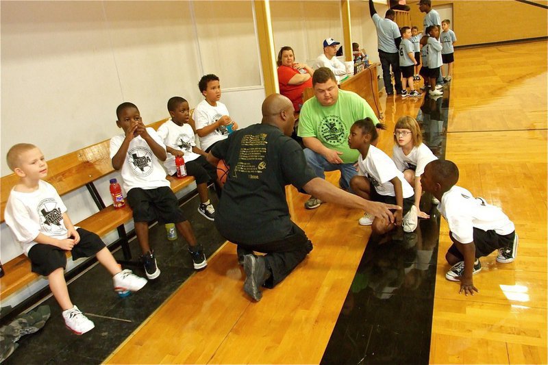 Image: Here’s the plan — Coaches Derrick Cunningham and Roy Stephens talk to their troops during a timeout.
