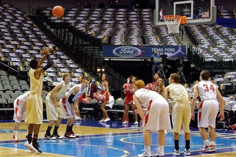 Image: Heath at the line — Gladiator Heath Clemons(2) puts in a free-throw as teammates Colton Campbell(5) and Jase Holden(3) get ready to rebound.
