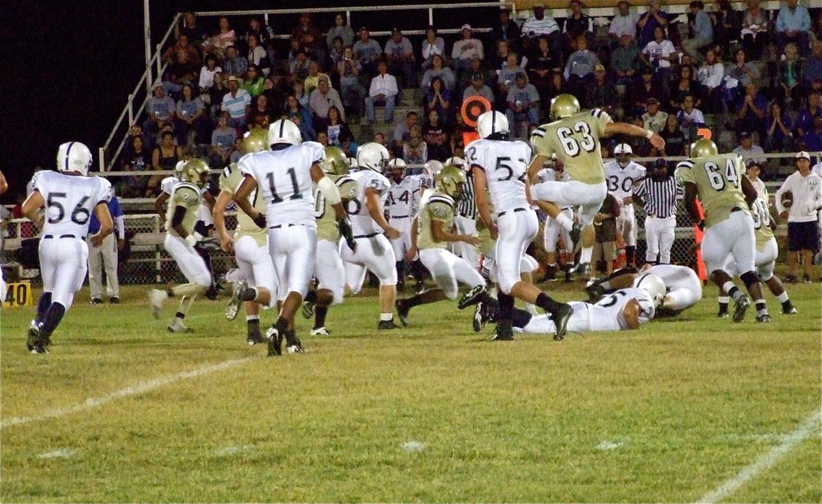 Image: Gladiators converge — Gladiators Heath Clemons(2), Kyle WIlkins(7), De’Andre Rettig(60), Kyle Jackson(28), Brandon Souder(63), Bobby Wilson(64), Jamal Jalarnce Lewis(30) hustle to the ball.