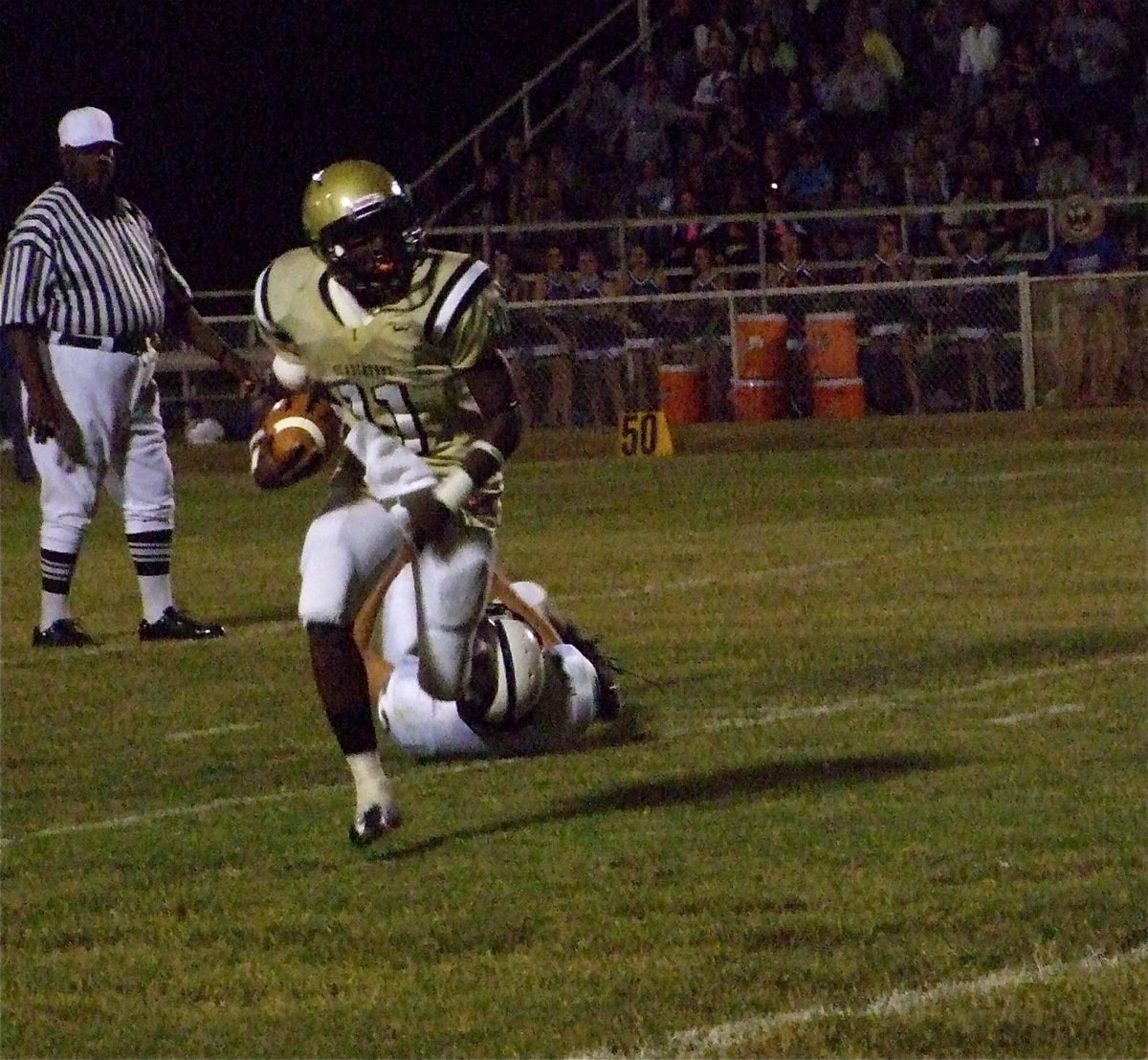 Image: Senio escapes — Gladiator quarterback Jasenio Anderson(11) escapes the clutches of a Leon Cougar tackler.