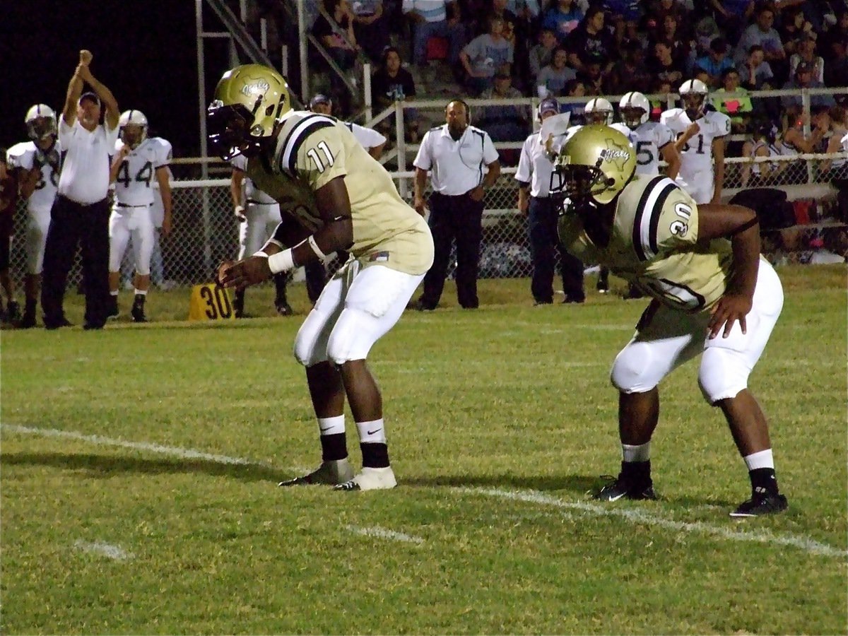 Image: Jasenio and Jamal — Jasenio Anderson(11) and Jamal Jalarnce Lewis(30) try to get the Gladiators into the endzone.